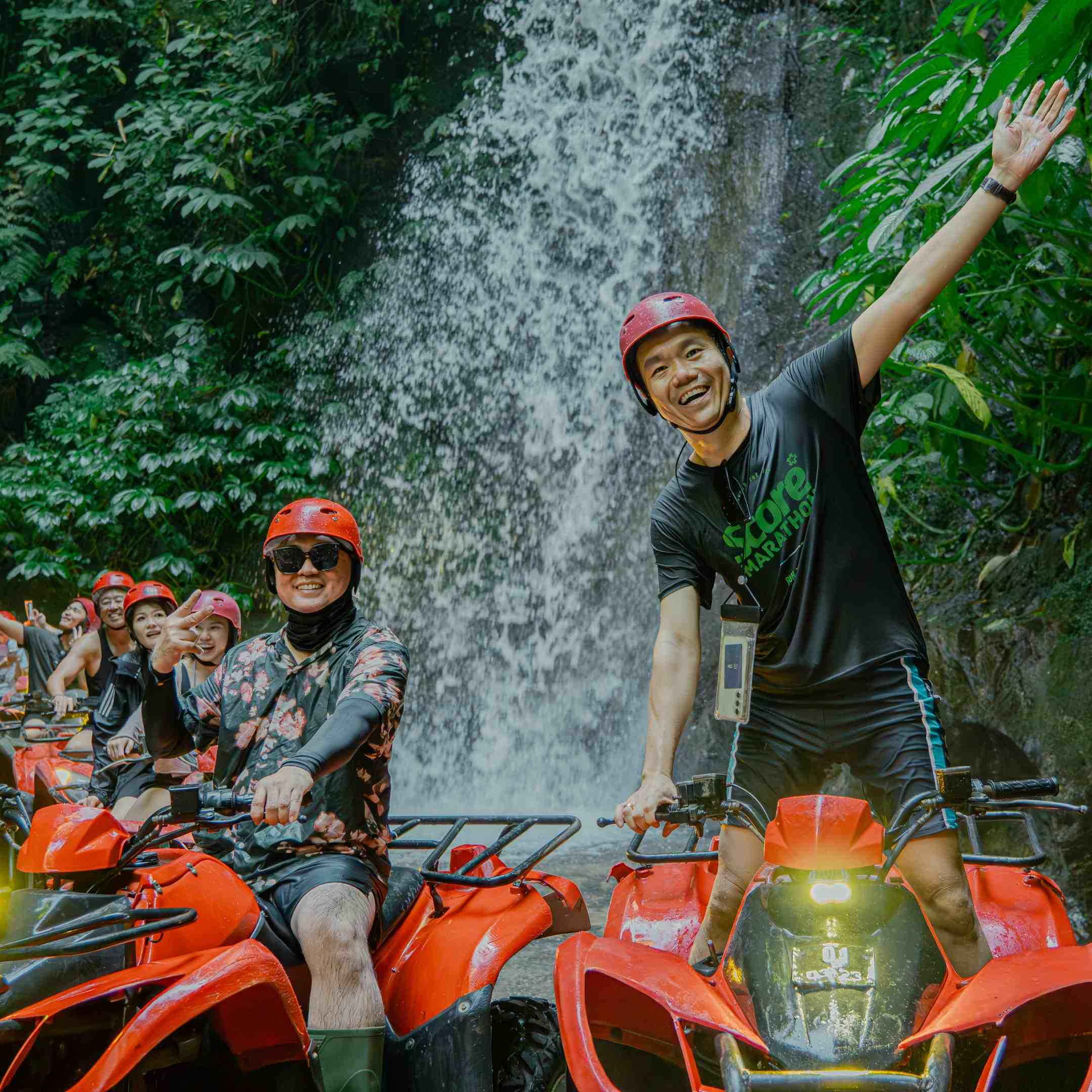 ATV riders crossing a muddy river section in Bali